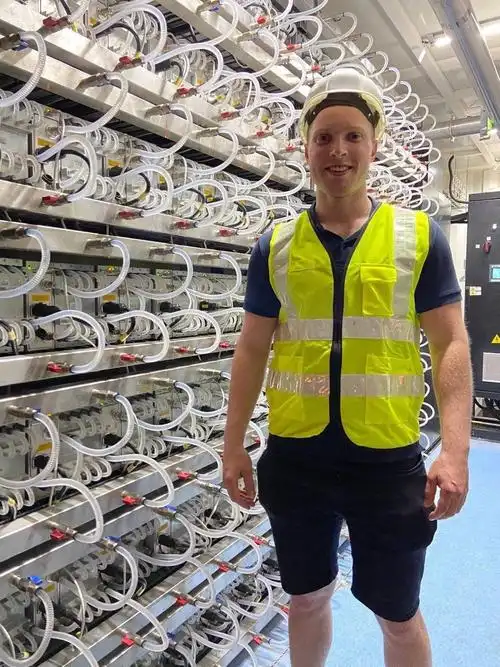Multiple mining rigs stacked in a server room, showcasing the scale of larger mining operations.